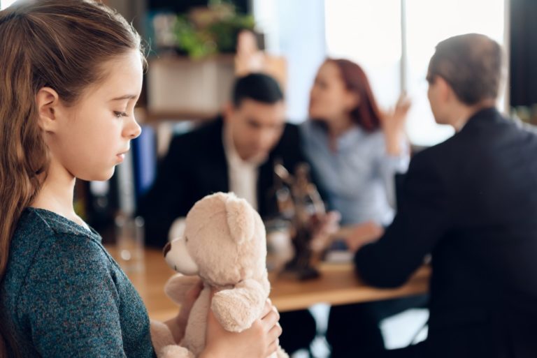 Child with parents arguing at the back