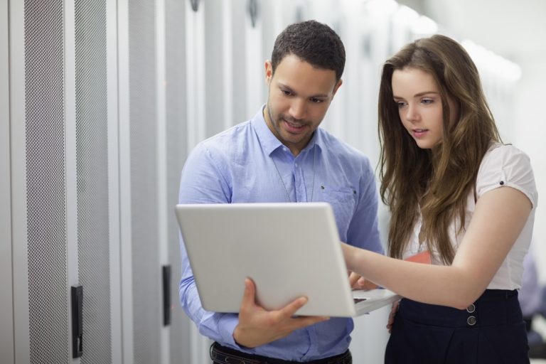 man and woman holding a laptop