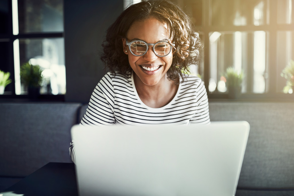 Female using laptop while smiling