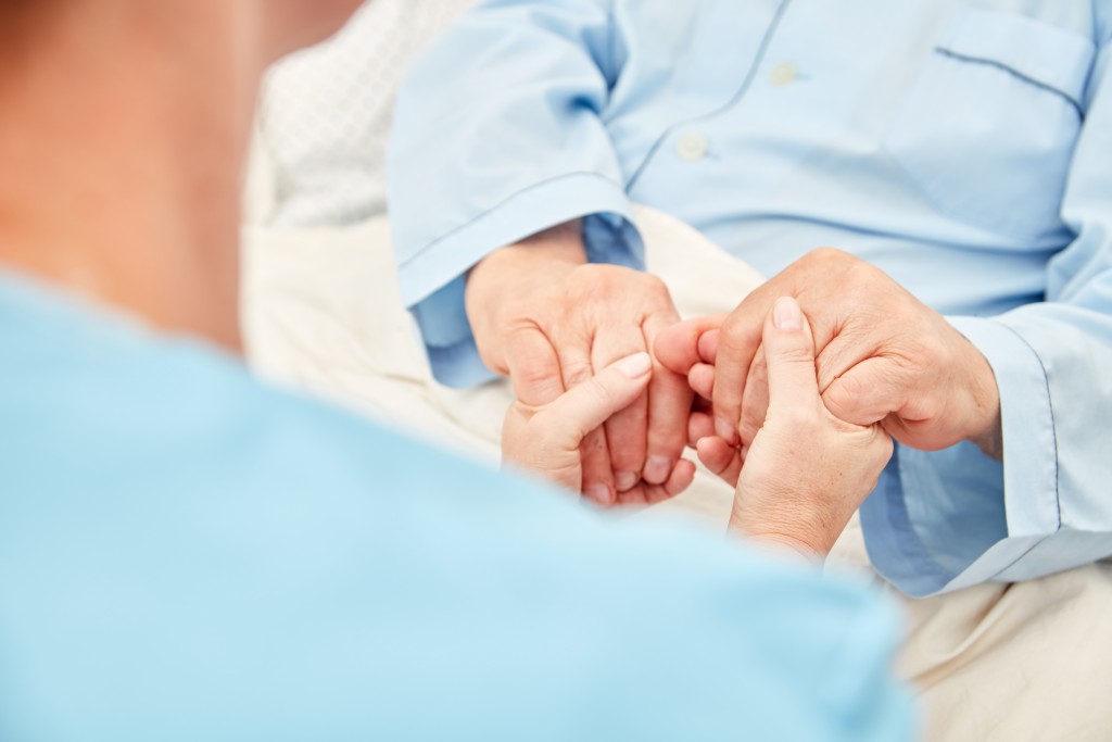 nurse holding the patient's hand