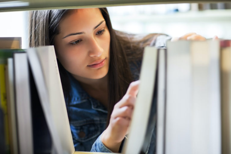 woman looking for a book