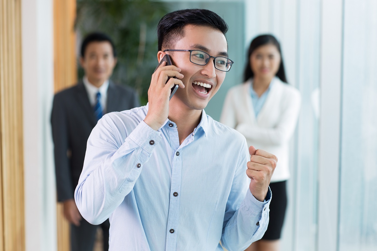 happy businessman talking on phone and shouting