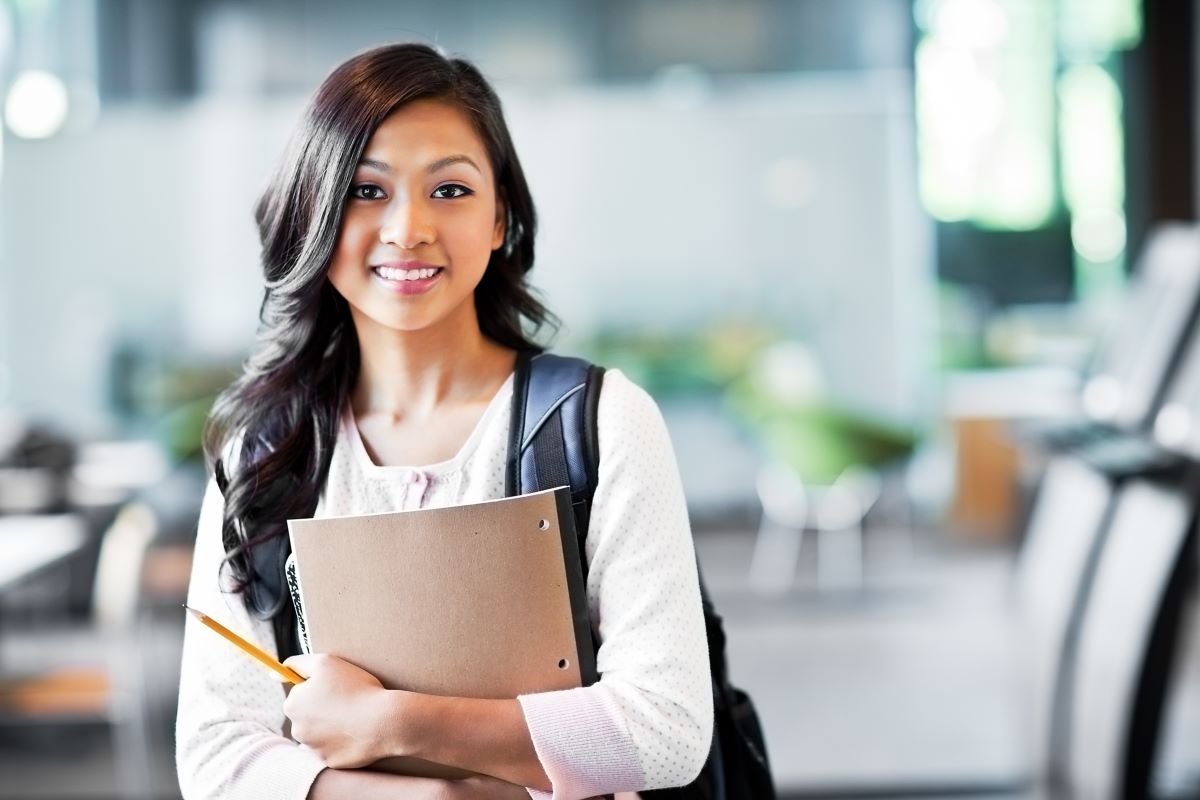 student holding books