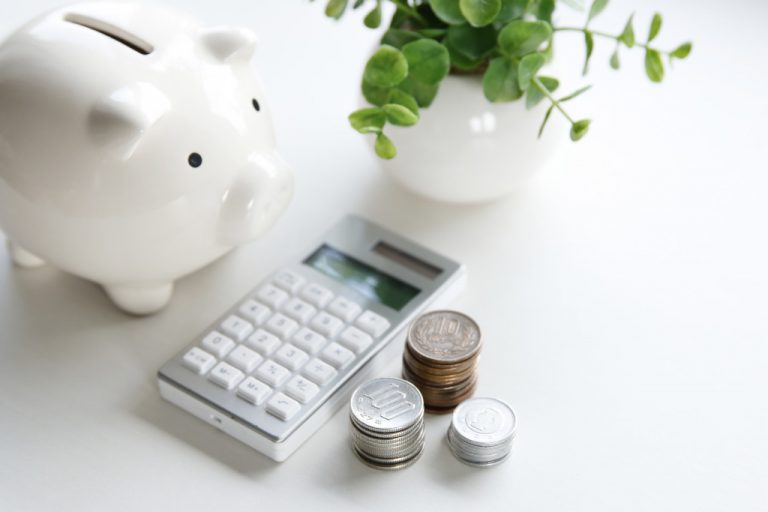 piggy bank calculator and coins