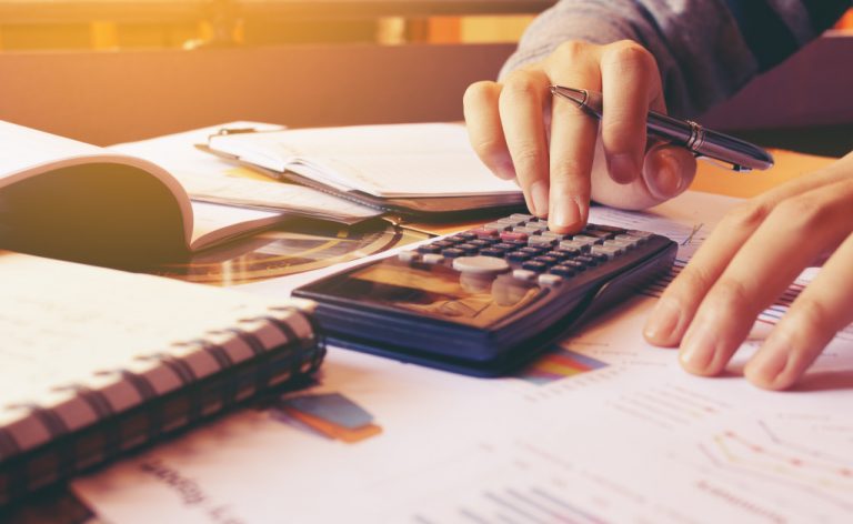 man with calculator and papers