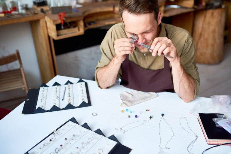 man inspecting gems
