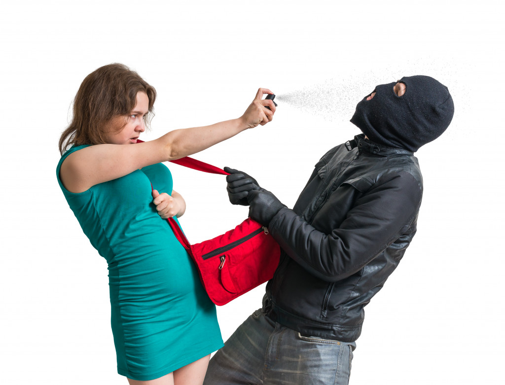 woman spraying pepper spray