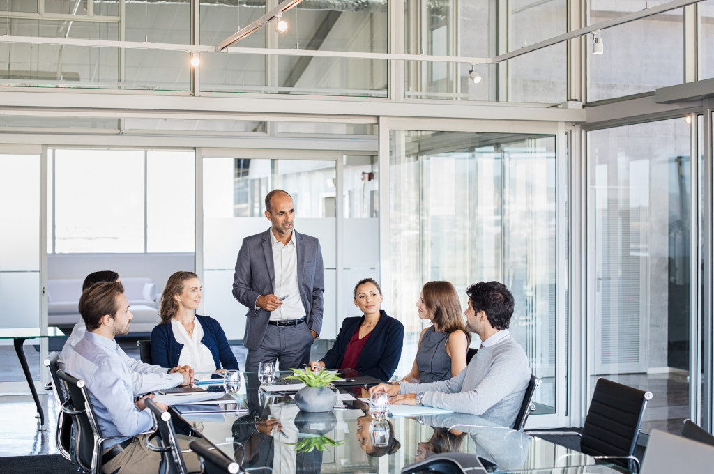 A businessman training his employees in a conference room