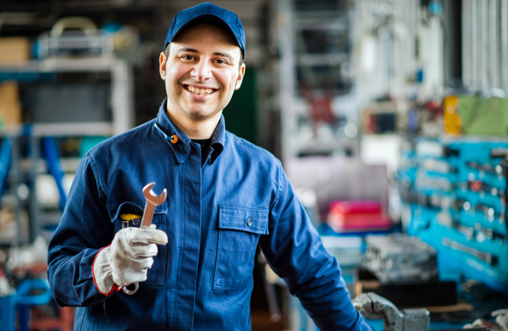 Auto mechanic smiling in his garage