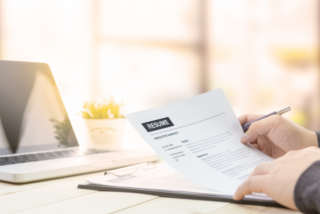 A business professional looking at a resume in an office