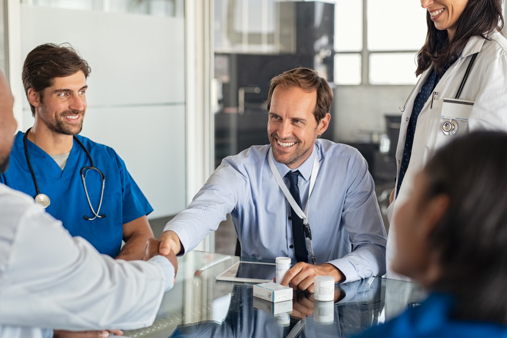 partnership in healthcare, professionals handshaking