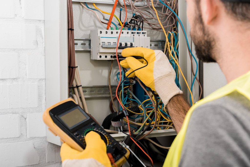 Electrician inspecting electrical lines