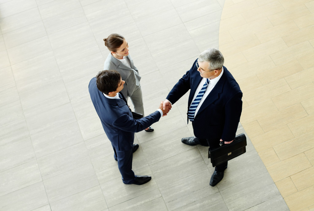 business man handshake in the lobby