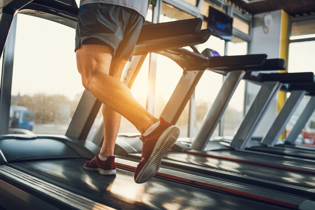 Young man exercising at a gym with the sun rising over the horizon.