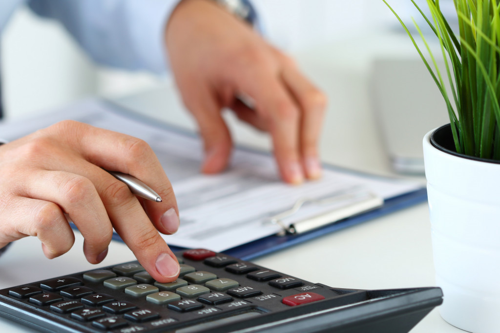 Close up of a hand computing using a calculator