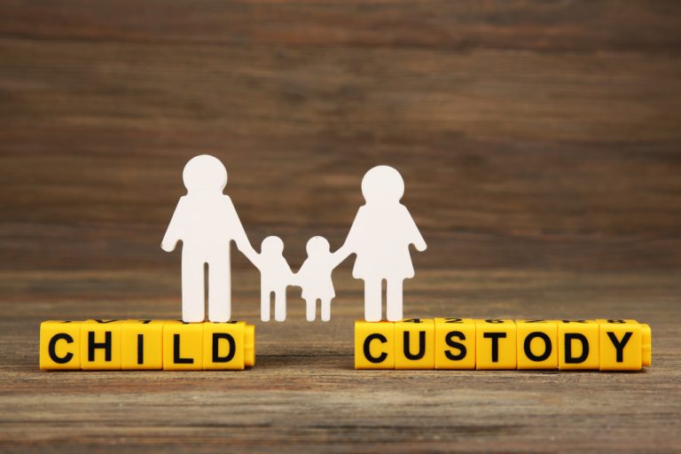 Letter blocks spelling the word CHILD CUSTODY with a family cutout on top