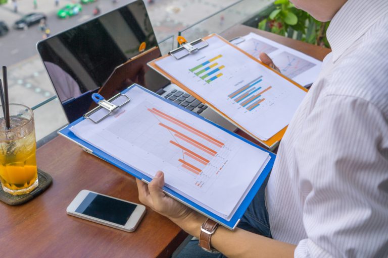 A businessman looking at graphs in a financial report