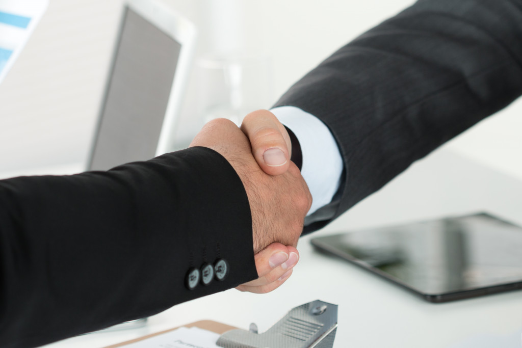 two people shaking hands after a deal