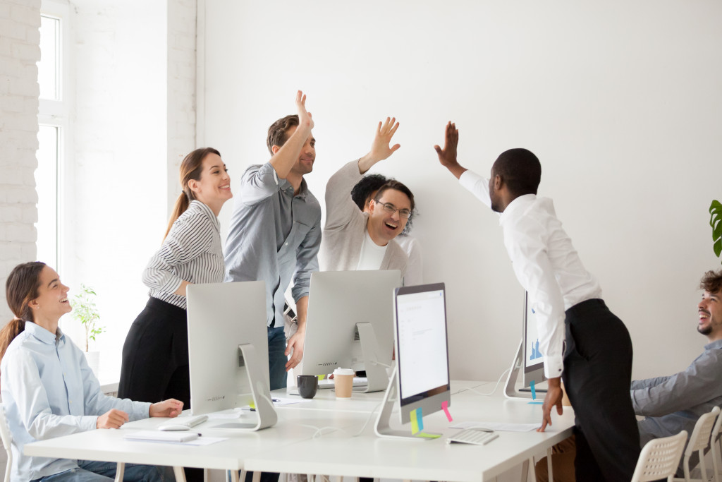 A group of employees cheering after a project success