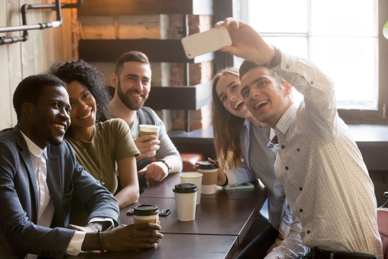 friends taking a group photo at a coffee shop