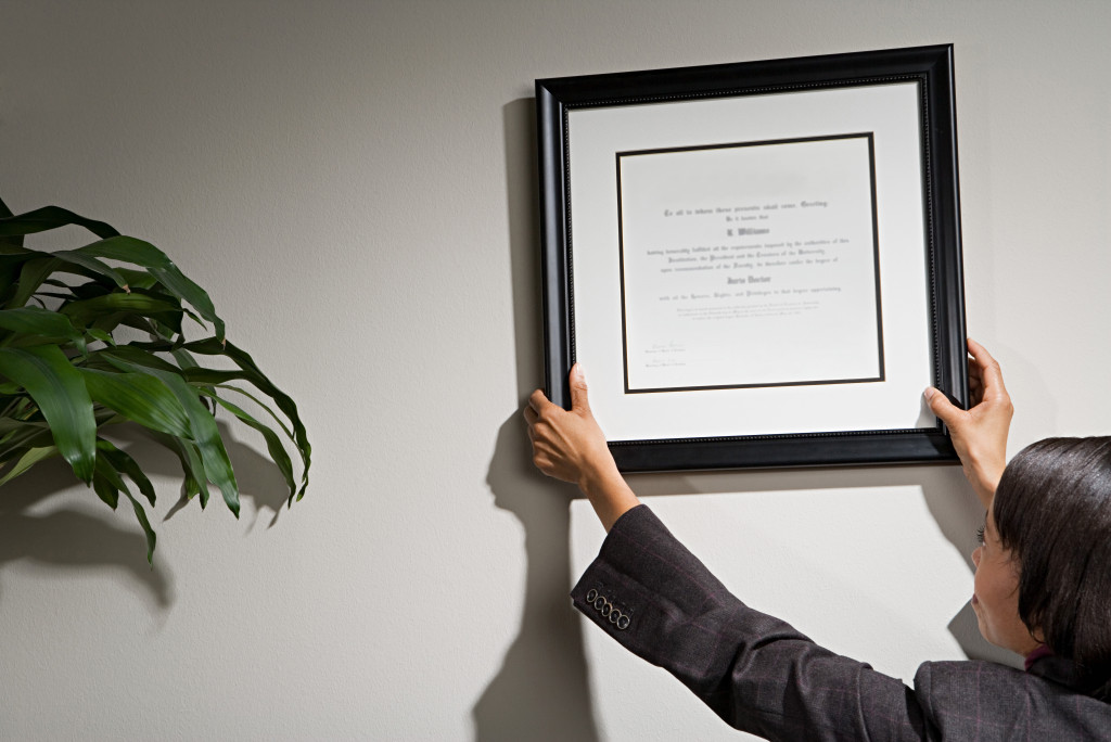 frame being hanged on a wall