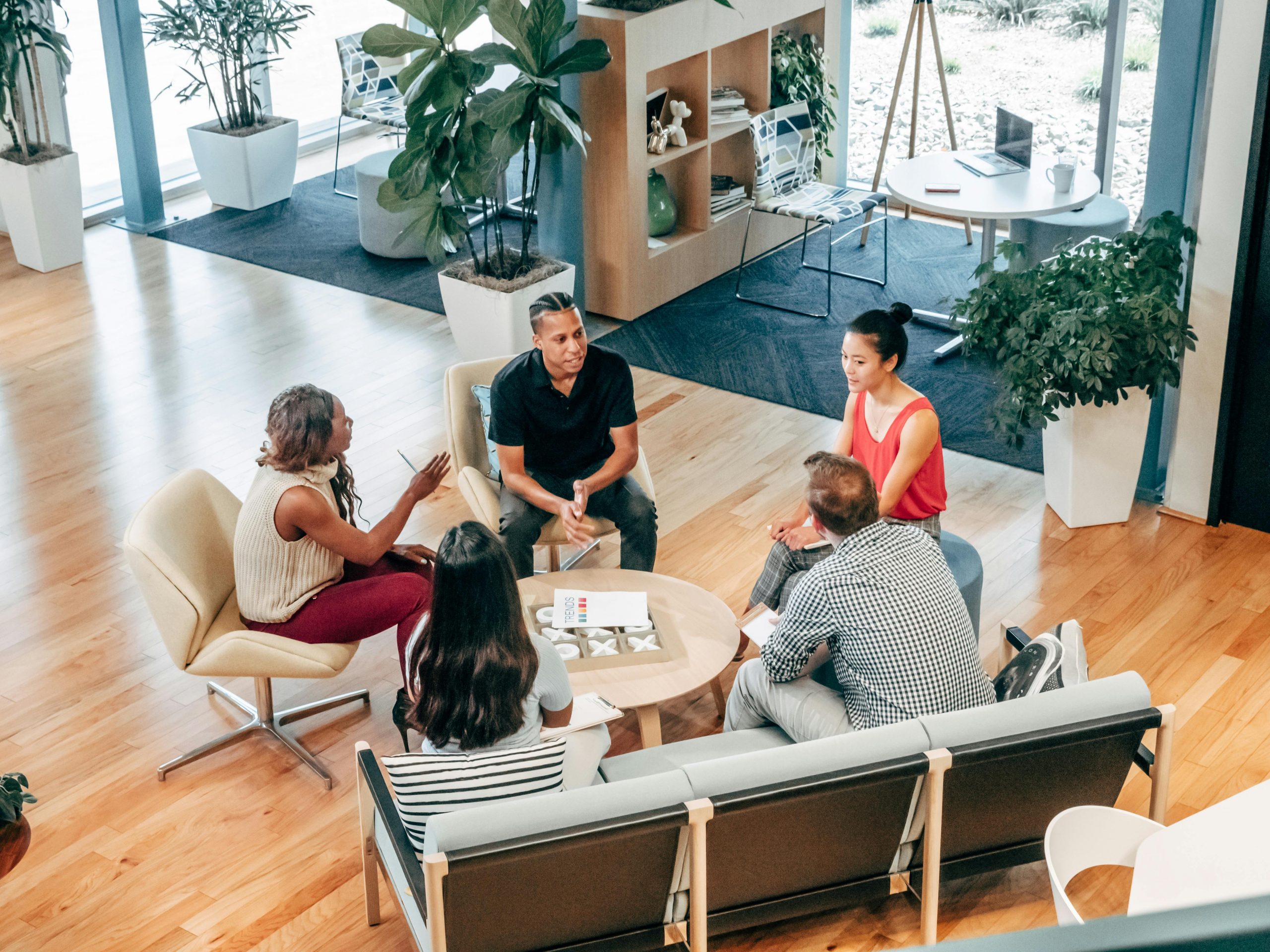 employees gathered in a huddle in a modern office